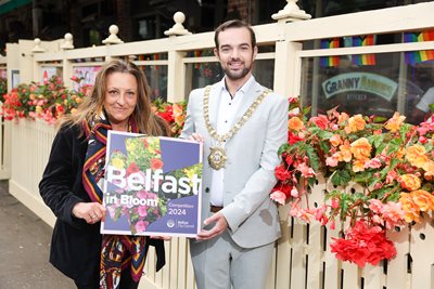 Lord Mayor with Lucy from Granny Annies beside colourful flower planters at Granny Annies