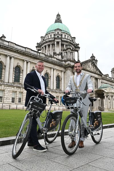 Dessi Derby and Lord Mayor on two newly branded Belfast Bikes outside City Hall