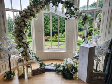 A flower ring and alter for a wedding ceremony overlooking the castle gardens