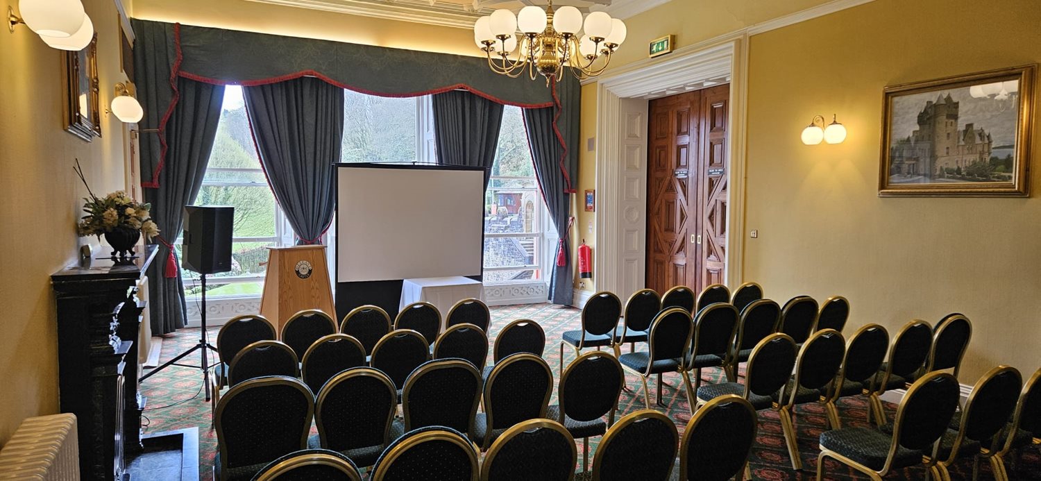 A theatre style set up in the Donegall Room including a presentation screen at the front. 