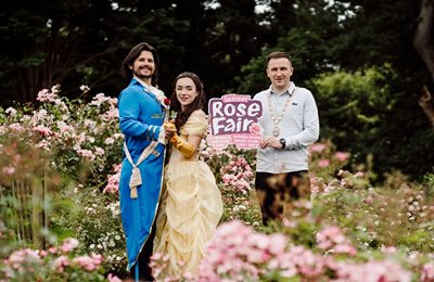 Deputy Lord Mayor with characters from Beauty and the Beast surrounded by roses to launch Summer Rose Fair